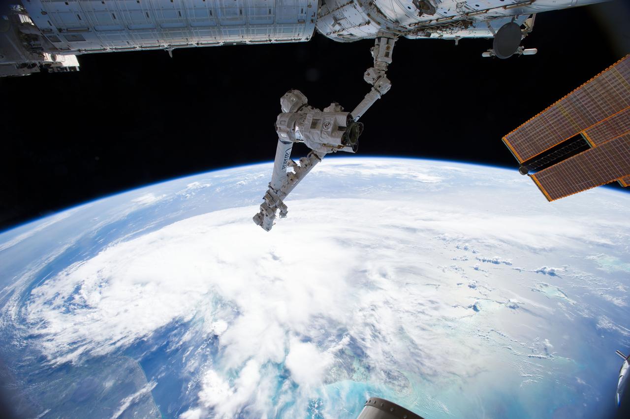 ISS040-E-030559 (2 July 2014) --- One of the Expedition 40 crew members aboard the Earth-orbiting International Space Station, some 227 nautical miles above Earth, photographed this image of Tropical Storm Arthur in the afternoon of July 2, 2014. Arthur was churning in Atlantic waters off the coast of Florida and slowly moving northward at the time the photo was taken. The robotic arm of the Space Station Remote Manipulator System or Canadarm2 is seen at upper center, and the tip of one of the orbital outpost's solar array panels is in upper right.