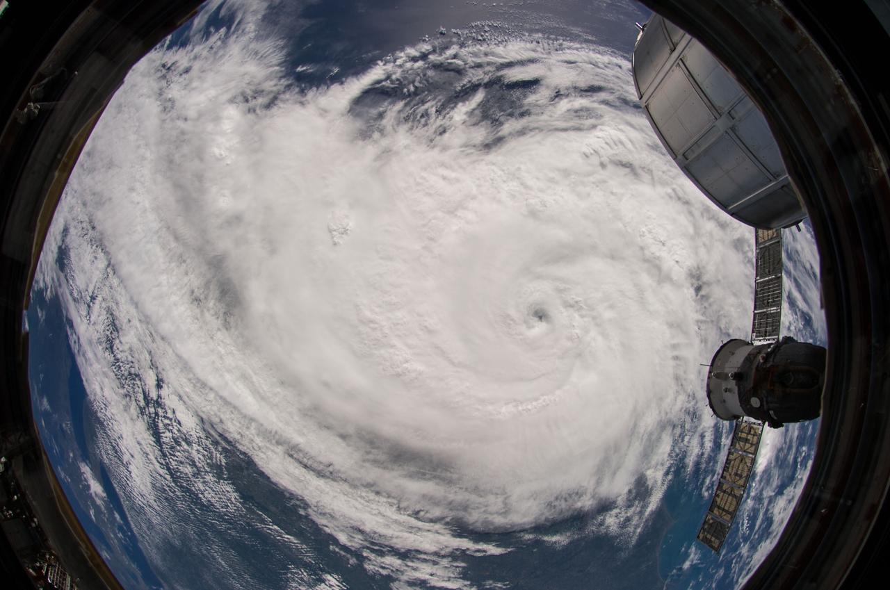 ISS040-E-033548 (4 July 2014) --- One of the Expedition 40 crew members aboard the Earth-orbiting International Space Station made use of a 10.5mm focal length to photograph this fish-eye view of Hurricane Arthur, which altered the holiday plans of millions of residents on the Atlantic Coast on U.S. Independence Day, 2014. This image was taken on July 4 at 13:32:41 GMT. One of the modules of the orbital outpost (top right) and a docked Russian spacecraft (right center) are visible in the photo.