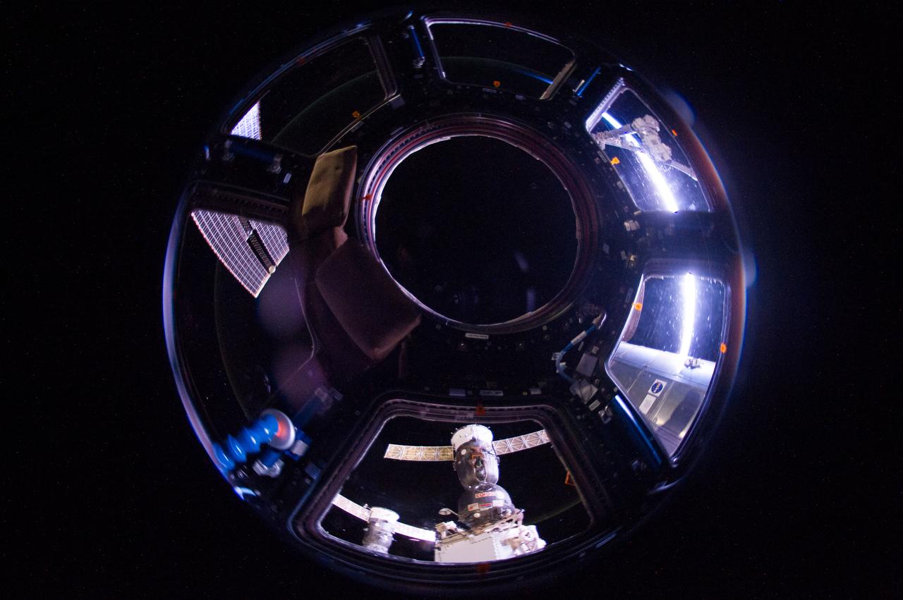ISS040-E-047594 (6 July 2014) --- One of the Expedition 40 crew members aboard the Earth-orbiting International Space Station recorded this image from inside the Cupola approximately 225 nautical miles above Polynesia. The photo was taken on July 6, 2014 at 16:18:22 GMT. A Russian Soyuz and Russian Progress vehicle can be seen docked to the orbital outpost at bottom center.