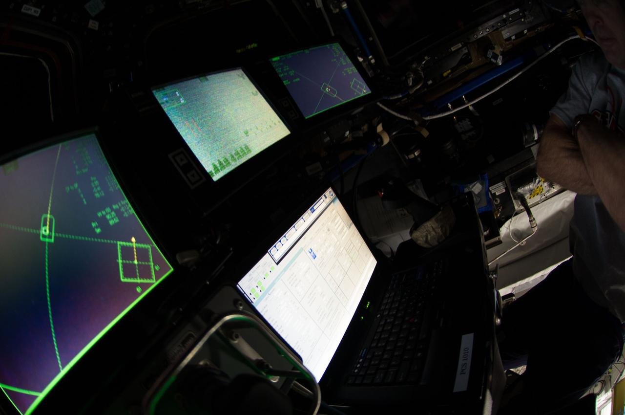 Control boards pictured in the International Space Stations Cupola during rendezvous and capture operations of the Orbital Sciences Cygnus cargo craft.