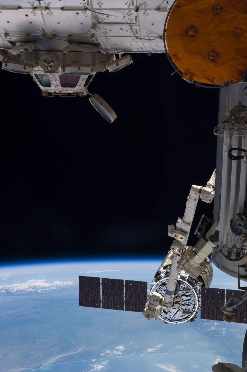 ISS040-E-068670 (16 July 2014) --- The capture of the Orbital Sciences? Cygnus cargo craft by the International Space Station?s Canadarm2 is photographed by an Expedition 40 crew member onboard the station. The two spacecraft converged at 6:36 a.m. (EDT) on July 16, 2014. Also visible in this image are the station?s Cupola and the Tranquility node (top). A blue and white part of Earth and the blackness of space provide the backdrop for the scene.