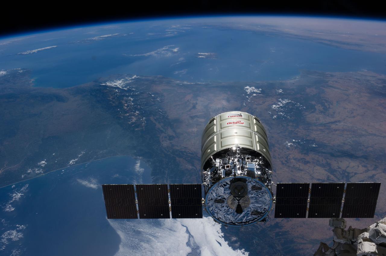 ISS040-E-069168 (16 July 2014) --- As photographed by an Expedition 40 crew member inside the International Space Station?s Cupola, Orbital Sciences? Cygnus cargo vehicle and the orbital outpost move toward each other at 223 nautical miles above the home planet. The two converged at 6:36 a.m. (EDT) on July 16, 2014. Parts of western Europe are visible in the background. A small part of the Space Station Remote Manipulator System or Canadarm2 can be seen as it waits to grapple Cygnus.