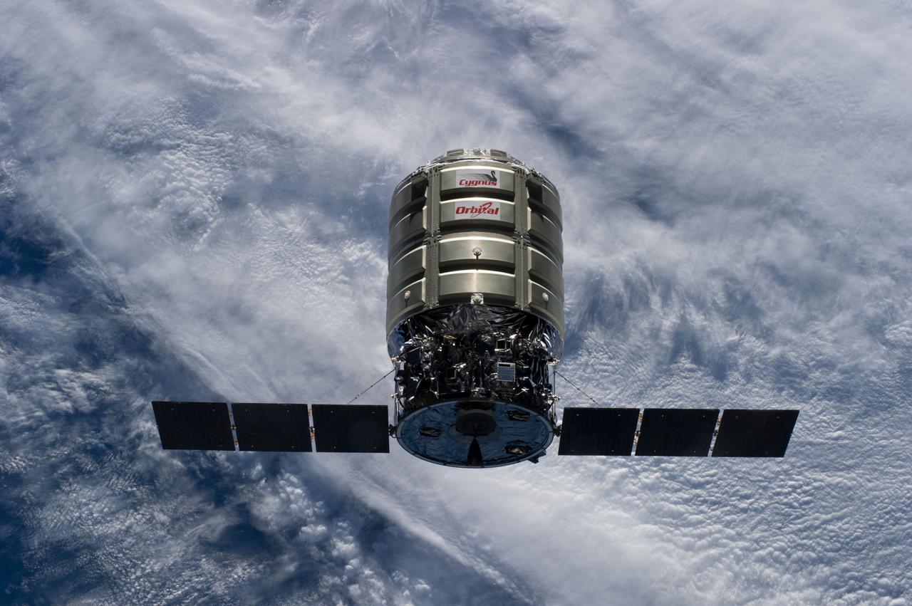 ISS040-E-069311 (16 July 2014) --- Backdropped by a cloud-covered part of Earth, the Orbital Sciences? Cygnus cargo craft approaches the International Space Station, photographed by an Expedition 40 crew member. The two spacecraft converged at 6:36 a.m. (EDT) on July 16, 2014.