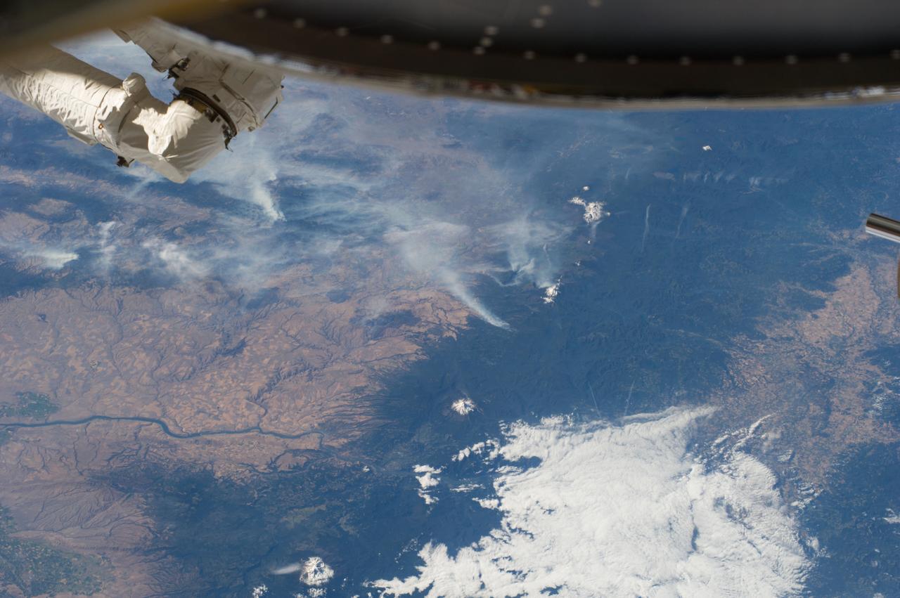 ISS040-E-070412 (19 July 2014) --- One of the Expedition 40 crew members aboard the Earth-orbiting International Space Station recorded this July 19 panorama featuring wildfires which are plaguing the Northwest and causing widespread destruction. (Note: south is at the top of the frame). The orbital outpost was flying 223 nautical miles above Earth at the time of the photo. Parts of Oregon and Washington are included in the scene. Mt. Jefferson, Three Sisters and Mt. St. Helens are all snow-capped and visible in the photo, and the Columbia River can also be delineated.