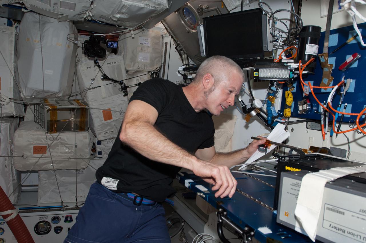 ISS040-E-074856 (23 July 2014) --- NASA astronaut Steve Swanson, Expedition 40 commander, works with hardware at a workstation in the Harmony node of the International Space Station.