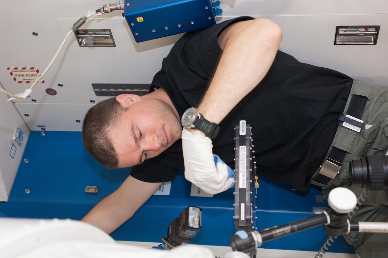 ISS040-E-076507 (25 July 2014) --- NASA astronaut Reid Wiseman, Expedition 40 flight engineer, conducts a session with the Binary Colloidal Alloy Test-C1, or BCAT-C1, experiment in the Kibo laboratory of the International Space Station. Results from this ongoing investigation of colloids ? mixtures of small particles distributed throughout a liquid ? will help materials scientists to develop new consumer products with unique properties and longer shelf lives.