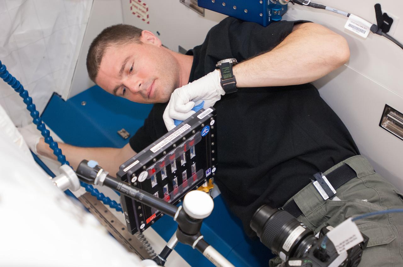 ISS040-E-076510 (25 July 2014) --- NASA astronaut Reid Wiseman, Expedition 40 flight engineer, conducts a session with the Binary Colloidal Alloy Test-C1, or BCAT-C1, experiment in the Kibo laboratory of the International Space Station. Results from this ongoing investigation of colloids ? mixtures of small particles distributed throughout a liquid ? will help materials scientists to develop new consumer products with unique properties and longer shelf lives.