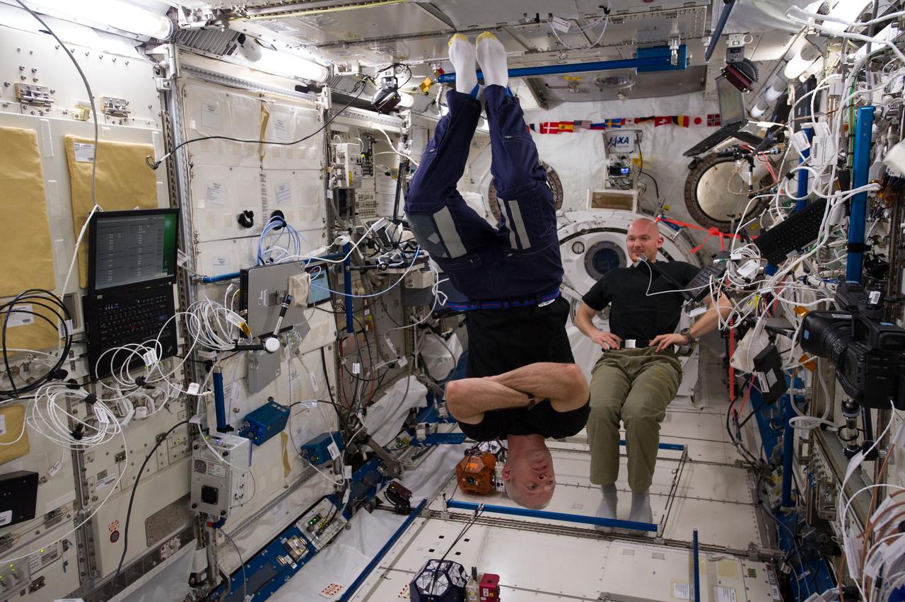 ISS040-E-079332 (25 July 2014) --- In the International Space Station?s Kibo laboratory, NASA astronaut Steve Swanson (foreground), Expedition 40 commander; and European Space Agency astronaut Alexander Gerst, flight engineer, conduct a session with a trio of soccer-ball-sized robots known as the Synchronized Position Hold, Engage, Reorient, Experimental Satellites, or SPHERES. The free-flying robots were equipped with stereoscopic goggles called the Visual Estimation and Relative Tracking for Inspection of Generic Objects, or VERTIGO, to enable the SPHERES to perform relative navigation based on a 3D model of a target object.