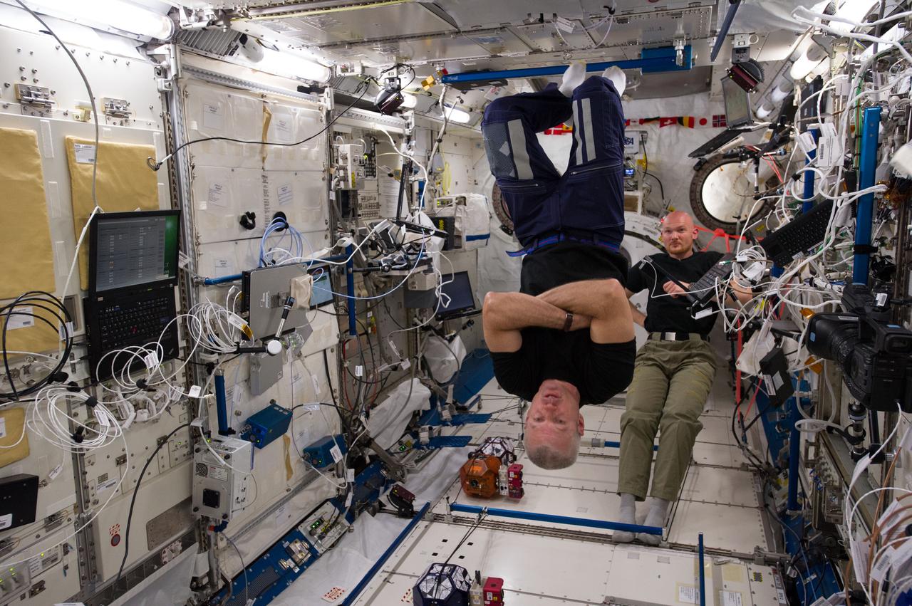 ISS040-E-079355 (25 July 2014) --- In the International Space Station?s Kibo laboratory, NASA astronaut Steve Swanson (foreground), Expedition 40 commander; and European Space Agency astronaut Alexander Gerst, flight engineer, conduct a session with a trio of soccer-ball-sized robots known as the Synchronized Position Hold, Engage, Reorient, Experimental Satellites, or SPHERES. The free-flying robots were equipped with stereoscopic goggles called the Visual Estimation and Relative Tracking for Inspection of Generic Objects, or VERTIGO, to enable the SPHERES to perform relative navigation based on a 3D model of a target object.