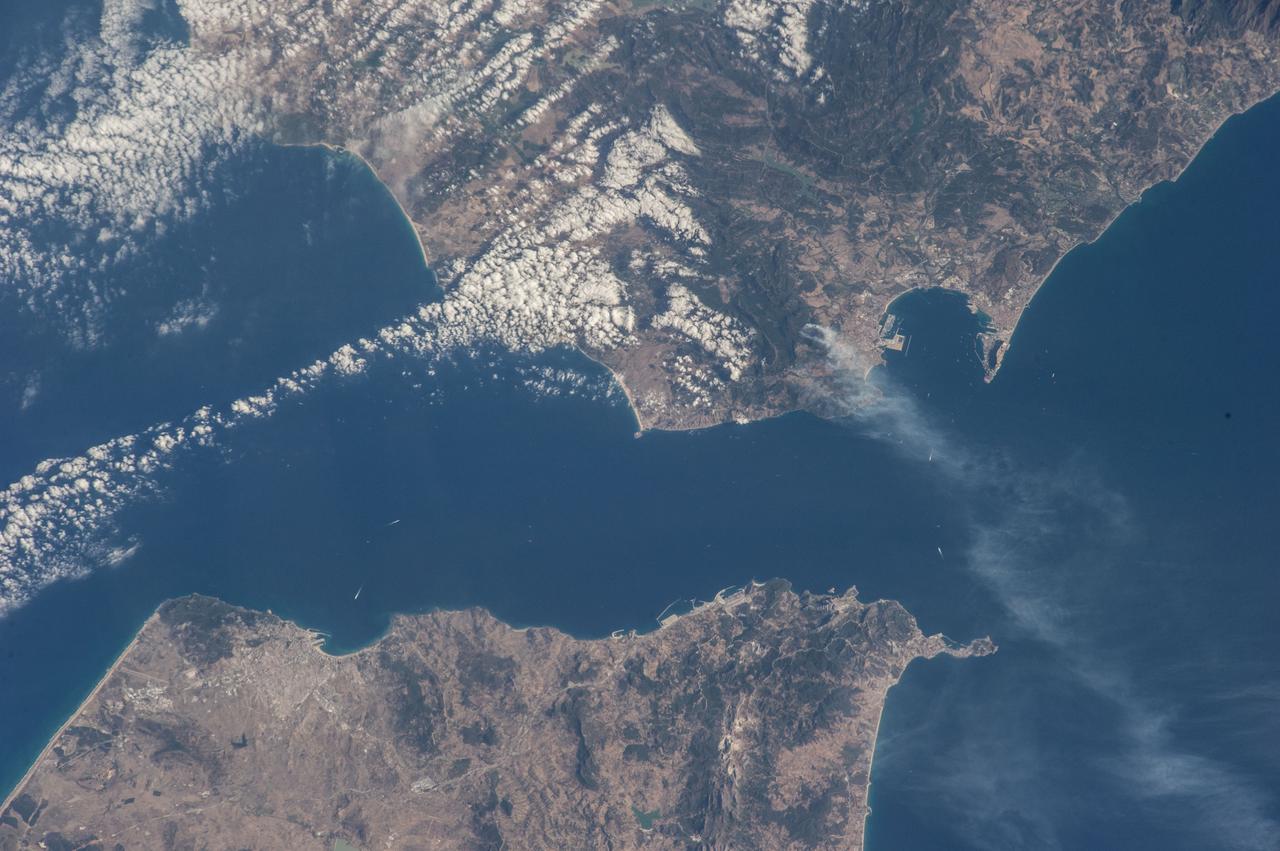 ISS040-E-081001 (25 July 2014) --- One of the Expedition 40 crew members aboard the Earth-orbiting International Space Station was aiming his camera almost straight down when he recorded this view of parts of Spain (top), Morocco (bottom) and the Strait of Gibraltar (center) at 08:04:35 GMT on July 25, 2014. Gibraltar and the Alboran Sea are on the right side of the frame. Cadiz, Spain is almost under clouds on the Bay of Cadiz above and to the left of frame center.
