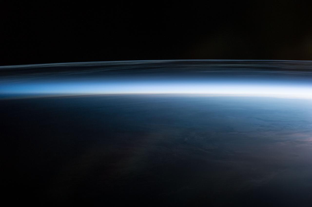 Earth Observation taken during a night pass by the Expedition 40 crew aboard the International Space Station (ISS). Folder lists this as: Polar Mesospheric Clouds over Canada.