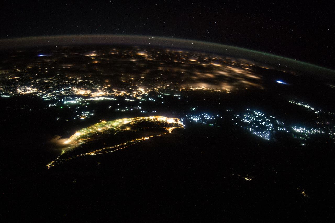 ISS040-E-081424 (27 July 2014) --- From an altitude of 223 nautical miles, one of the Expedition 40 crew members aboard the International Space Station on July 27, 2014 recorded this oblique night image of Taiwan (center foreground) and part of mainland China. Hundreds of fishing vessels, perhaps for harvesting both fish and squid as well as other forms of marine life, are seen in clusters throughout the panorama. Two lightning storms -- one on either side of the image -- are also visible.
