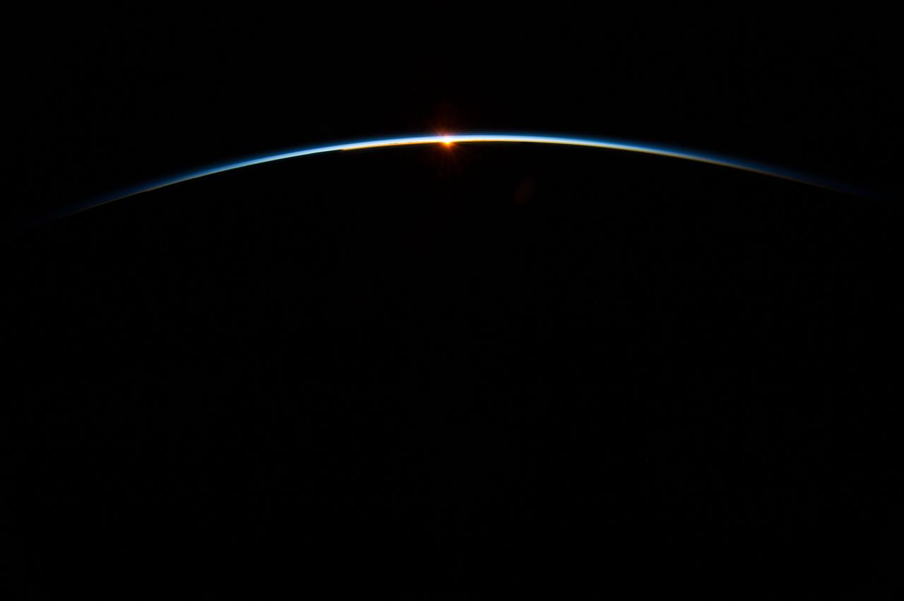 ISS040-E-083603 (31 July 2013) --- The sun, peeking through the thin line of Earth's atmosphere, is featured in this image photographed by an Expedition 40 crew member on the International Space Station. Crew members onboard the space station see, on average, sixteen sunrises and sunsets during a 24-hour orbital period.