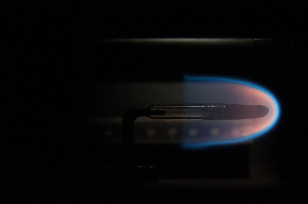 Image taken on card 15 during BASS-II flame test session with reduced O2 partial pressure. Session conducted on GMT 214. The Burning and Suppression of Solids - II (BASS-II) investigation examines the burning and extinction characteristics of a wide variety of fuel samples in microgravity. The BASS-II experiment will guide strategies for materials flammability screening for use in spacecraft as well as provide valuable data on solid fuel burning behavior in microgravity. BASS-II results contribute to the combustion computational models used in the design of fire detection and suppression systems in microgravity and on Earth.