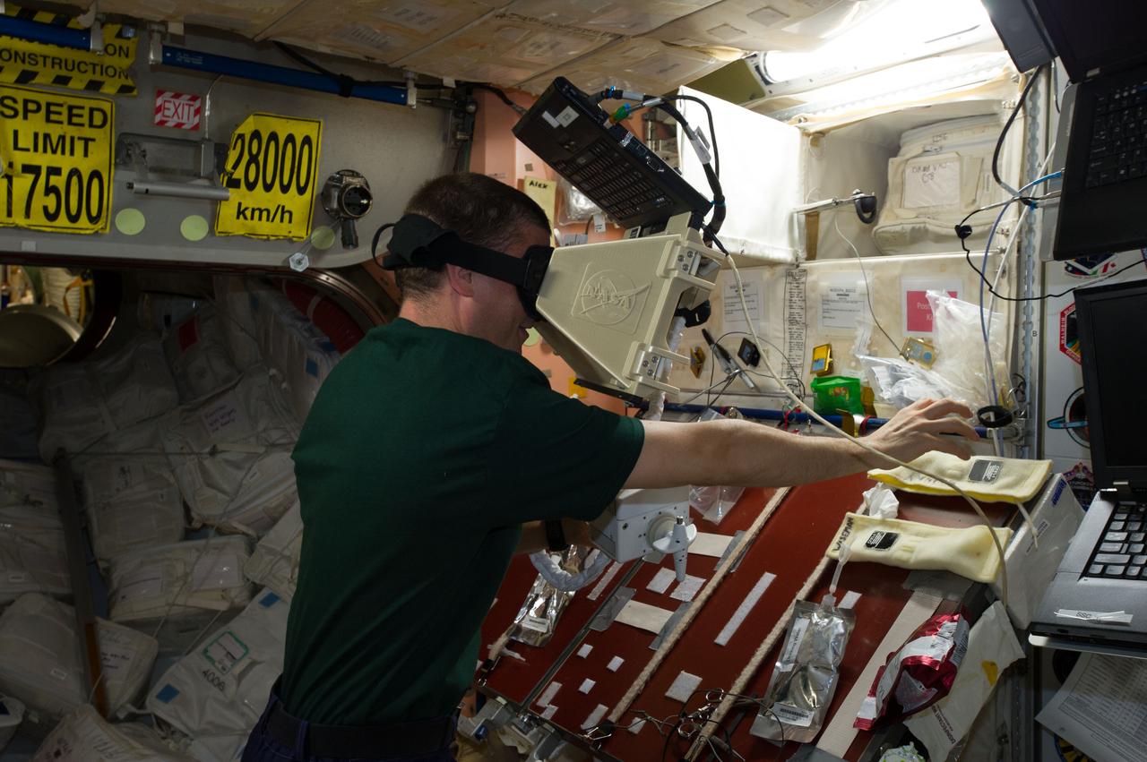 ISS040-E-088794 (5 Aug. 2014) --- In the Unity node of the International Space Station, NASA astronaut Reid Wiseman, Expedition 40 flight engineer, uses a laptop computer 3D virtual spacewalk trainer in preparation for two upcoming U.S. sessions of extravehicular activity (EVA).