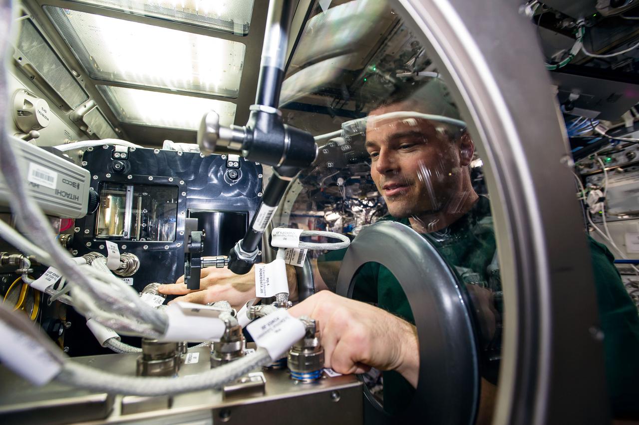 ISS040-E-088856 (5 Aug. 2014) --- NASA astronaut Reid Wiseman, Expedition 40 flight engineer, installs Capillary Channel Flow (CCF) experiment hardware in the Microgravity Science Glovebox (MSG) located in the Destiny laboratory of the International Space Station. CCF is a versatile experiment for studying a critical variety of inertial-capillary dominated flows key to spacecraft systems that cannot be studied on the ground.