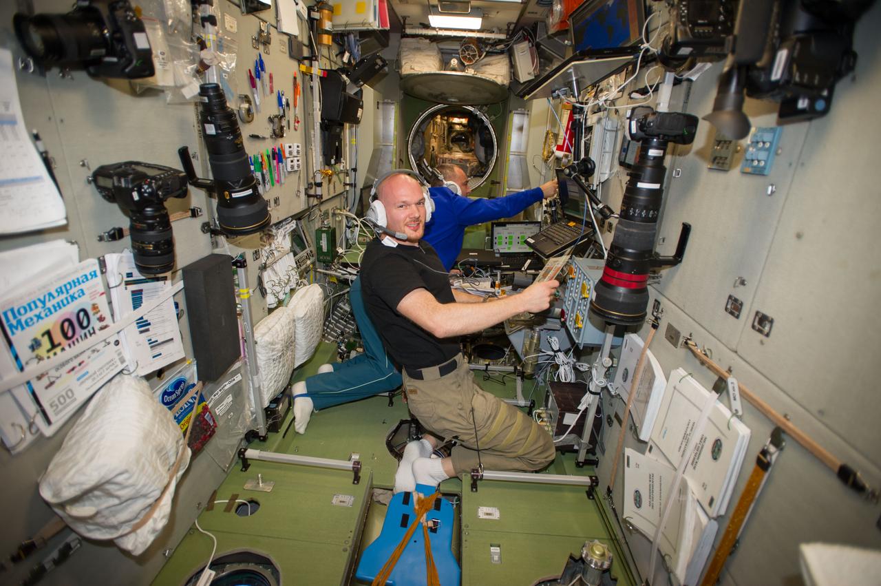 ISS040-E-089627 (7 Aug. 2014) --- In the International Space Station?s Zvezda Service Module, European Space Agency astronaut Alexander Gerst (foreground) and Russian cosmonaut Alexander Skvortsov, both Expedition 40 flight engineers, participate in a training session in preparation for the rendezvous and docking of ESA?s fifth and final Automated Transfer Vehicle (ATV-5). Nicknamed the ?Georges Lemaitre? in honor of the Belgian physicist and astronomer who first proposed the Big Bang theory, ATV-5 will deliver more than seven tons of scientific experiments, food and other supplies when it docks to the aft end of Zvezda on Aug. 12.