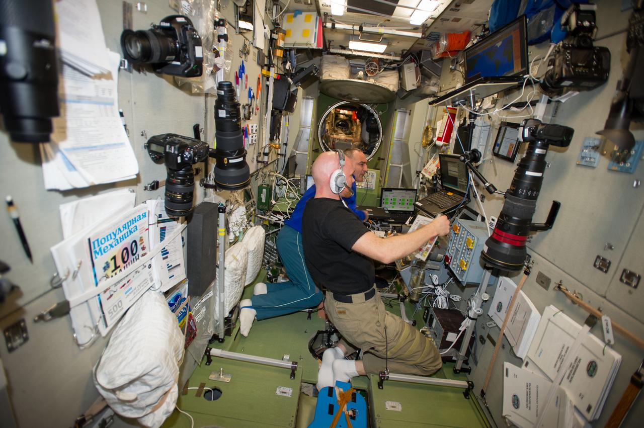 ISS040-E-089629 (7 Aug. 2014) --- In the International Space Station?s Zvezda Service Module, European Space Agency astronaut Alexander Gerst (foreground) and Russian cosmonaut Alexander Skvortsov, both Expedition 40 flight engineers, participate in a training session in preparation for the rendezvous and docking of ESA?s fifth and final Automated Transfer Vehicle (ATV-5). Nicknamed the ?Georges Lemaitre? in honor of the Belgian physicist and astronomer who first proposed the Big Bang theory, ATV-5 will deliver more than seven tons of scientific experiments, food and other supplies when it docks to the aft end of Zvezda on Aug. 12.