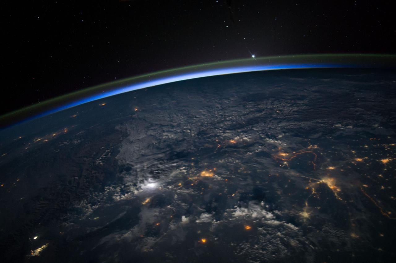Earth Observation taken during a night pass by the Expedition 40 crew aboard the International Space Station (ISS). Folder lists this as: night pass over India with a bright moon and thunderstorms.