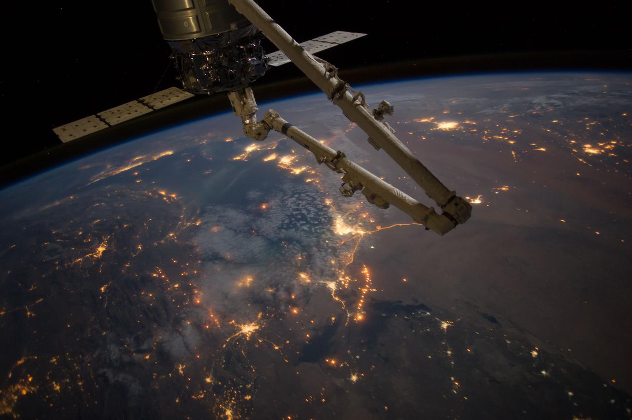 Earth Observation taken during a night pass by the Expedition 40 crew aboard the International Space Station (ISS). Folder lists this as: Middle East. The Space Station Remote Manipulator System (SSRMS) arm is also visible.