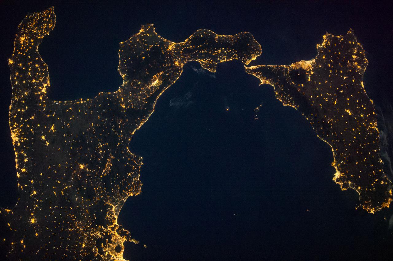 ISS040-E-090718 (9 Aug. 2014) --- One of the Expedition 40 crew members aboard the International Space Station, flying 225 nautical miles above Earth, recorded this night view over southern Italy on Aug. 9, 2014. South is at the top of the picture. Italy's "boot" and Sicily are featured in the 28mm image.