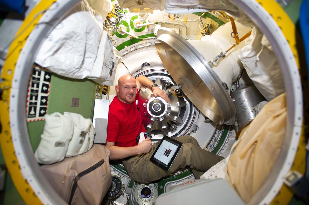 ISS040-E-091919 (13 Aug. 2014) --- European Space Agency astronaut Alexander Gerst, Expedition 40 flight engineer, prepares to remove the docking mechanism to gain access to the hatch of the newly attached "Georges Lemaitre" Automated Transfer Vehicle-5 (ATV-5).