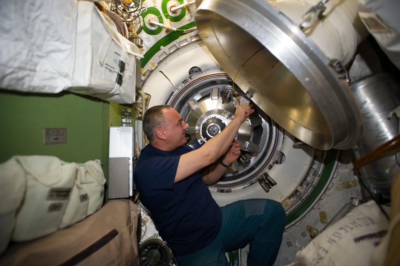 ISS040-E-091940 (13 Aug. 2014) --- Russian cosmonaut Alexander Skvortsov, Expedition 40 flight engineer, prepares to remove the docking mechanism to gain access to the hatch of the newly attached "Georges Lemaitre" Automated Transfer Vehicle-5 (ATV-5).