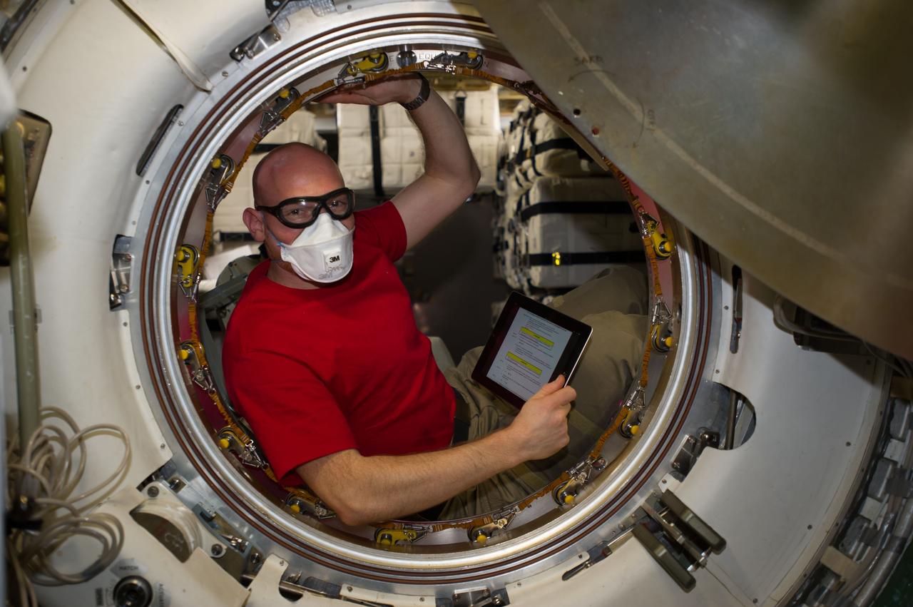 ISS040-E-091979 (13 Aug. 2014) --- European Space Agency astronaut Alexander Gerst, Expedition 40 flight engineer, is pictured in the hatch after removing the docking mechanism of the newly-attached "Georges Lemaitre" Automated Transfer Vehicle-5 (ATV-5) of the International Space Station.