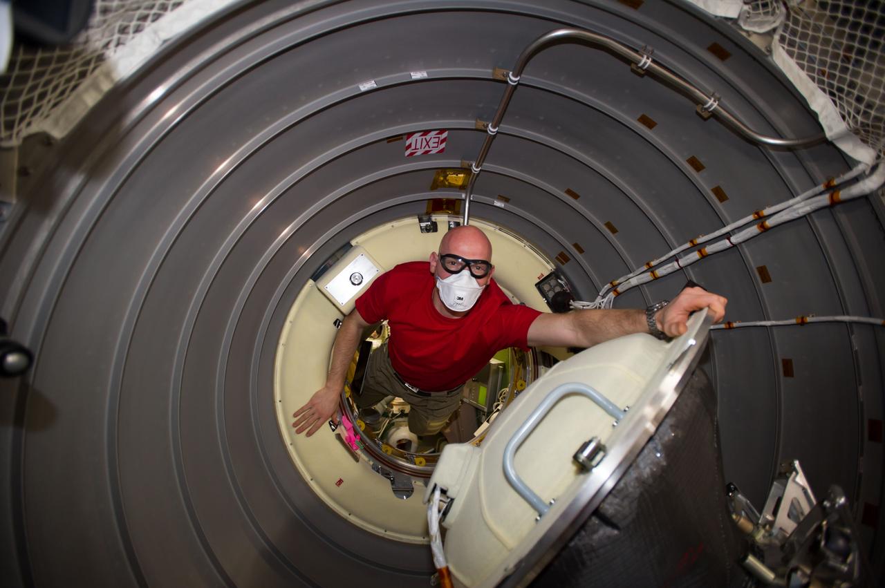 ISS040-E-091989 (13 Aug. 2014) --- European Space Agency astronaut Alexander Gerst, Expedition 40 flight engineer, enters the newly-attached "Georges Lemaitre" Automated Transfer Vehicle-5 (ATV-5) of the International Space Station.