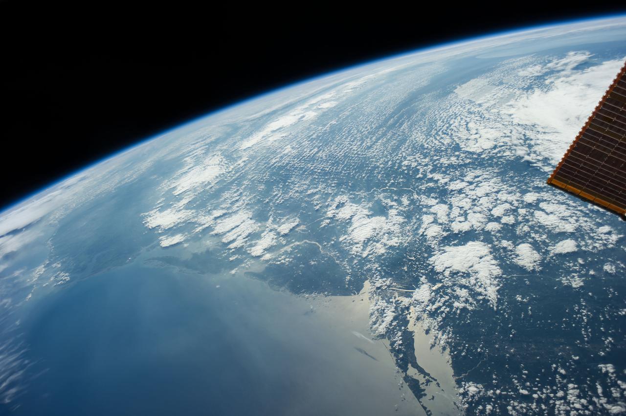 ISS040-E-093914 (14 Aug. 2014) --- One of the Expedition 40 crew members aboard the International Space Station, flying at an altitude of 219 nautical miles, recorded this oblique panorama of much of the eastern seaboard from the northern tip of New York's Long Island (loer right) southward into the Carolinas.  Some of the Great Lakes would be visible in the background were it not for heavy cloud cover. [Note: After the change of command onboard the orbital outpost, the Expedition 41 crew members one month later took a night photograph (ISS041e016740) of this basic area along the Atlantic Coast, featuring night lights of a number of major cities.]
