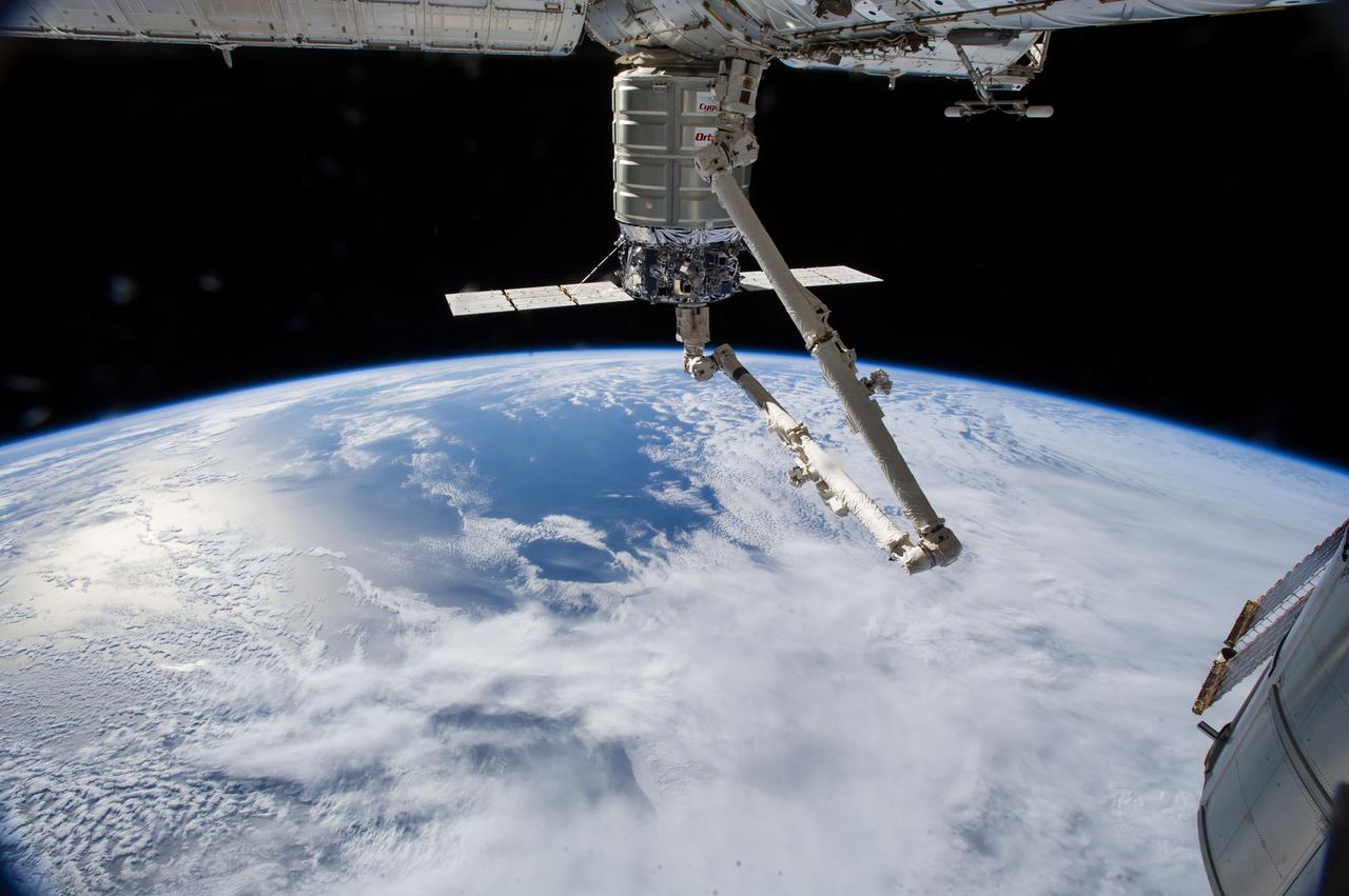ISS040-E-094430 (15 Aug. 2014) --- The International Space Station?s Canadarm2 unberths the Orbital Sciences' Cygnus commercial cargo craft after a month visiting the orbital outpost. European Space Agency astronaut Alexander Gerst and NASA astronaut Reid Wiseman, both Expedition 40 flight engineers, were at the controls of the robotics workstation in the Cupola removing Cygnus from the Harmony node then safely releasing at 6:40 a.m. (EDT) Aug. 15, 2014. A blue and white part of Earth and the blackness of space provide the backdrop for the scene.