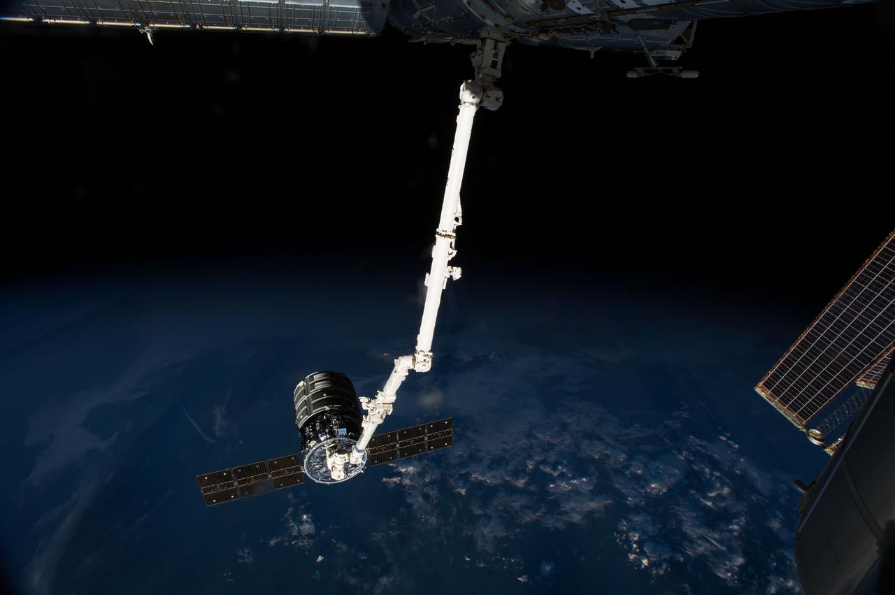 ISS040-E-094885 (15 Aug. 2014) --- The International Space Station’s Canadarm2 prepares to release the Orbital Sciences' Cygnus commercial cargo craft after a month visiting the orbital outpost. European Space Agency astronaut Alexander Gerst and NASA astronaut Reid Wiseman, both Expedition 40 flight engineers, were at the controls of the robotics workstation in the Cupola removing Cygnus from the Harmony node then safely releasing at 6:40 a.m. (EDT) Aug. 15, 2014.