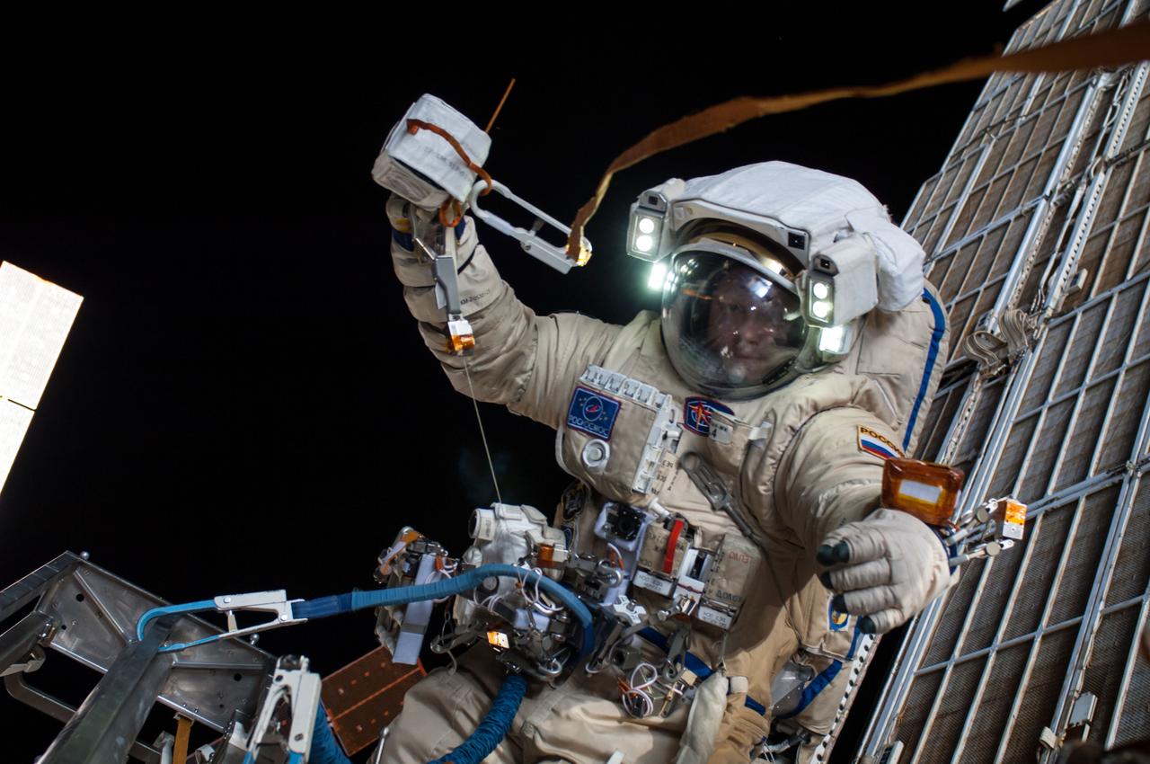 ISS040-E-099097 (18 Aug. 2014) --- Russian cosmonaut Oleg Artemyev, Expedition 40 flight engineer, attired in a Russian Orlan spacesuit, participates in a session of extravehicular activity (EVA) in support of science and maintenance on the International Space Station. During the five-hour, 11-minute spacewalk, Artemyev and Alexander Skvortsov (out of frame) deployed a small science satellite, retrieved and installed experiment packages and inspected components on the exterior of the orbital laboratory.