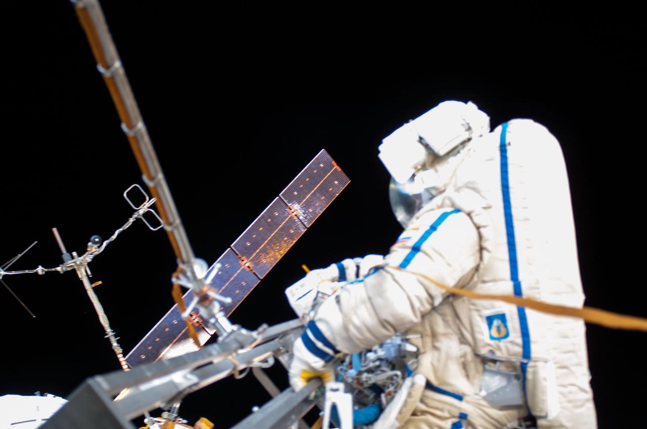 ISS040E099104 (08/18/2014) --- View of Cosmonaut Oleg Artemyev (blue stripe), Expedition 40 flight engineer outside the International Space Station, taken while performing maintenance work on the Russian segment during the Russian EVA 39 on Aug 18 2014.