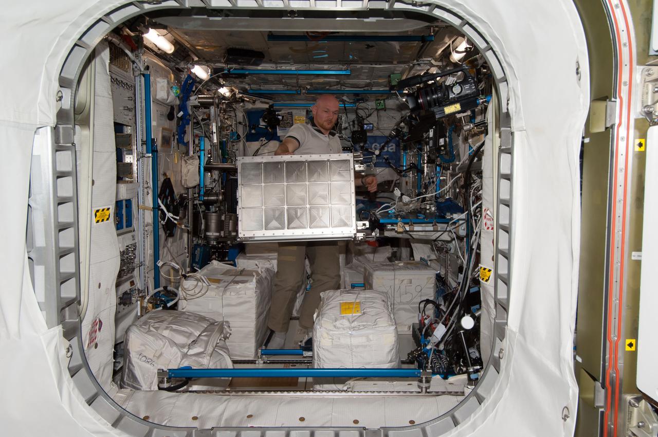 iss040e104595 (8/22/2014) --- European Space Agency (ESA) astronaut Alex Gerst is photographed removing the Facility for Absorption and Surface Tension (FASTER) hardware from the European Drawer Rack (EDR) and packing it for return on a future flight for refurbishment. The photo taken in the Columbus modulel aboard the International Space Station (ISS). The Facility for Adsorption and Surface Tension (FASTER) investigates the physical principles which determine the stability of different emulsions, and which compounds can influence this.