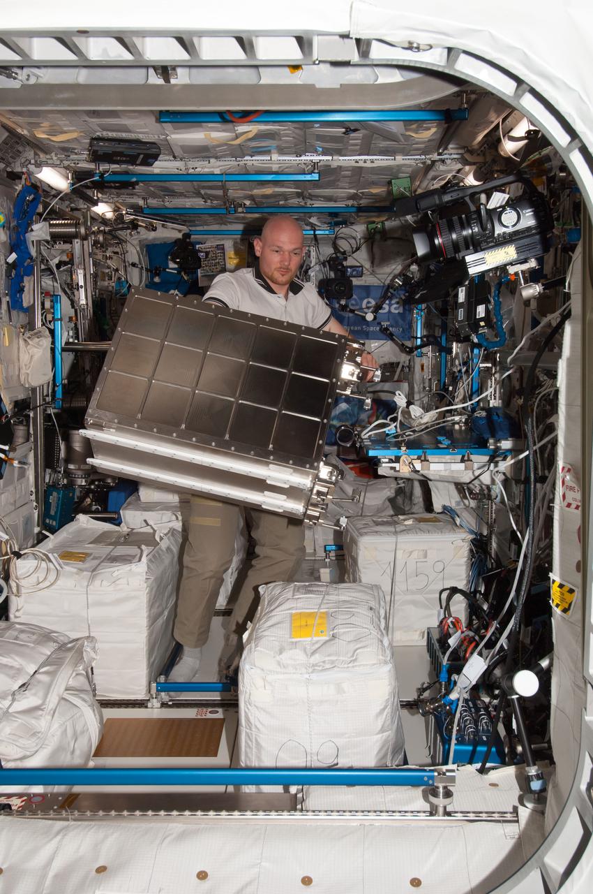 iss040e1045956 (8/22/2014) --- European Space Agency (ESA) astronaut Alex Gerst is photographed removing the Facility for Absorption and Surface Tension (FASTER) hardware from the European Drawer Rack (EDR) and packing it for return on a future flight for refurbishment. The photo taken in the Columbus modulel aboard the International Space Station (ISS). The Facility for Adsorption and Surface Tension (FASTER) investigates the physical principles which determine the stability of different emulsions, and which compounds can influence this.
