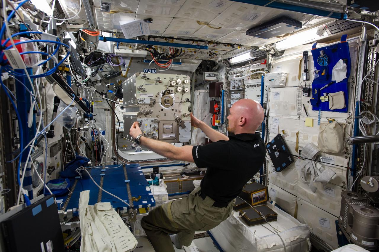 iss040e108044 (8/21/2014) — European Space Agency (ESA) astronaut Alexander Gerst, is shown in the Columbus module of the International Space Station (ISS) during the installation of the Electromagnetic Levitator (EML). The EML multi-user facility is designed for containerless materials processing in space.