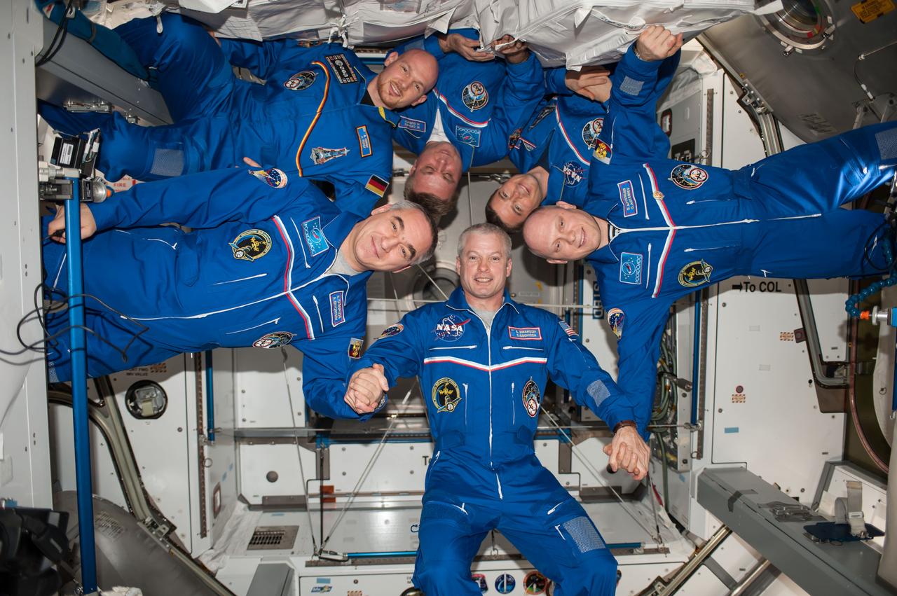 ISS040-E-112403 (23 Aug. 2014) --- Expedition 40 crew members pose for an in-flight crew portrait in the Harmony node of the International Space Station. Pictured clockwise are NASA astronaut Steve Swanson (bottom), commander; Russian cosmonaut Alexander Skvortsov, European Space Agency astronaut Alexander Gerst, Russian cosmonaut Maxim Suraev, NASA astronaut Reid Wiseman and Russian cosmonaut Oleg Artemyev, all flight engineers.