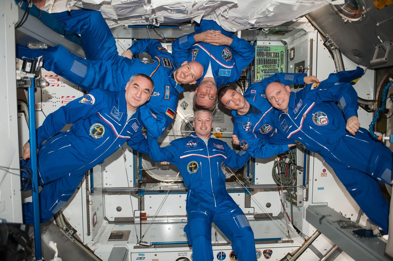 ISS040-E-112408 (23 Aug. 2014) --- Expedition 40 crew members pose for an in-flight crew portrait in the Harmony node of the International Space Station. Pictured clockwise are NASA astronaut Steve Swanson (bottom), commander; Russian cosmonaut Alexander Skvortsov, European Space Agency astronaut Alexander Gerst, Russian cosmonaut Maxim Suraev, NASA astronaut Reid Wiseman and Russian cosmonaut Oleg Artemyev, all flight engineers.