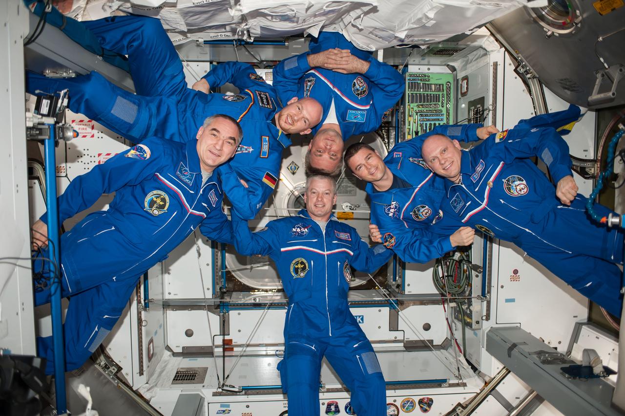 ISS040-E-112410 (23 Aug. 2014) --- Expedition 40 crew members pose for an in-flight crew portrait in the Harmony node of the International Space Station. Pictured clockwise are NASA astronaut Steve Swanson (bottom), commander; Russian cosmonaut Alexander Skvortsov, European Space Agency astronaut Alexander Gerst, Russian cosmonaut Maxim Suraev, NASA astronaut Reid Wiseman and Russian cosmonaut Oleg Artemyev, all flight engineers.