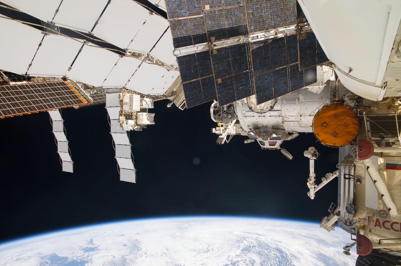 ISS040-E-123163 (2 Sept. 2014) --- Various solar array panels, the Rassvet Mini-Research Module 1 (MRM1) (right) and the Tranquility node with the Cupola (center) are featured in this image photographed by an Expedition 40 crew member aboard the International Space Station. Earth’s horizon and the blackness of space provide the backdrop for the scene.