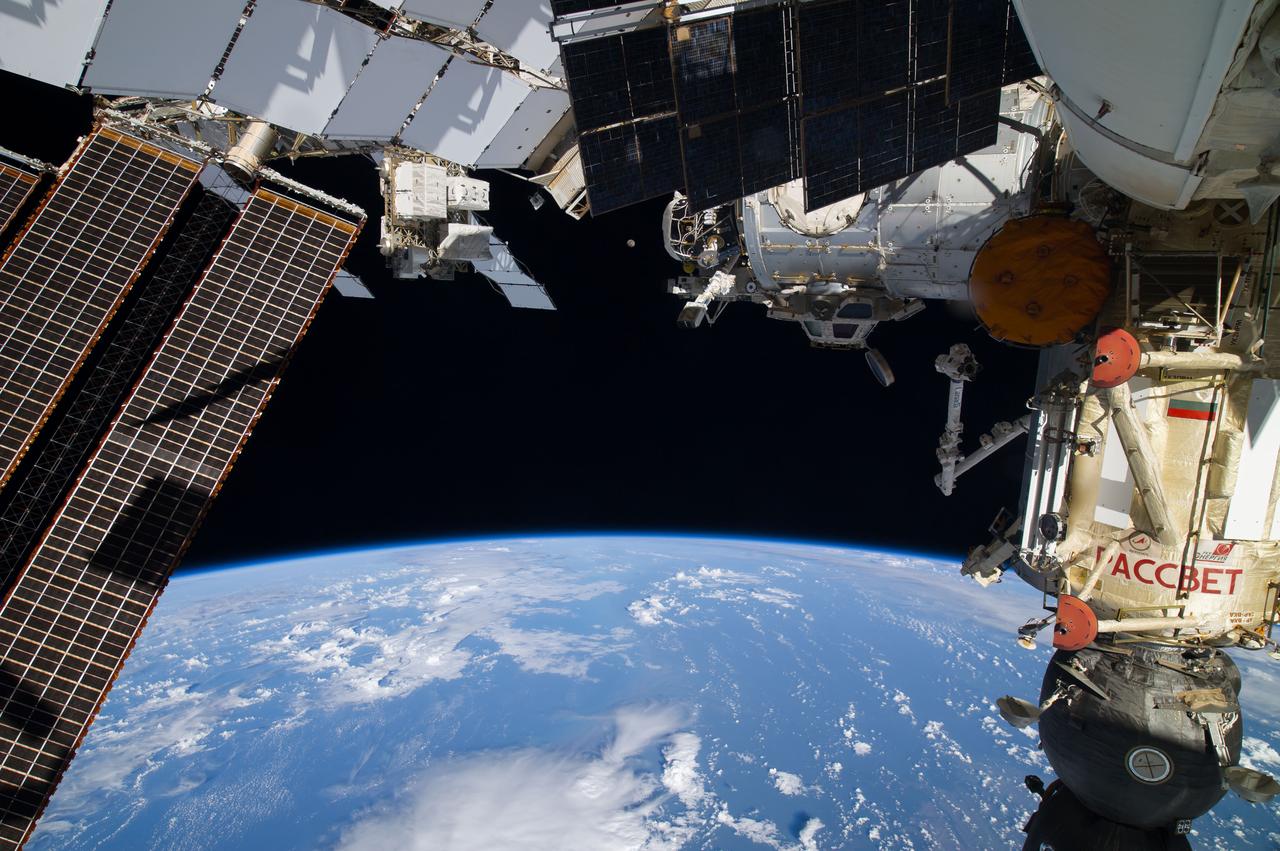 ISS040-E-127888 (6 Sept. 2014) --- A close look at this image, photographed by one of the Expedition 40 crew members onboard the International Space Station at 228 nautical miles above Earth, reveals a waxing gibbous moon in center frame. The image was taken as the orbital outpost was flying over the southwest Pacific in the area of New Zealand. The NanoRacks Cubesat deployer, attached to the Japan Aerospace Exploration Agency’s Kibo robotic arm, can be seen in upper right. Soyuz 39 TMA-13M is on Rassvet at right.