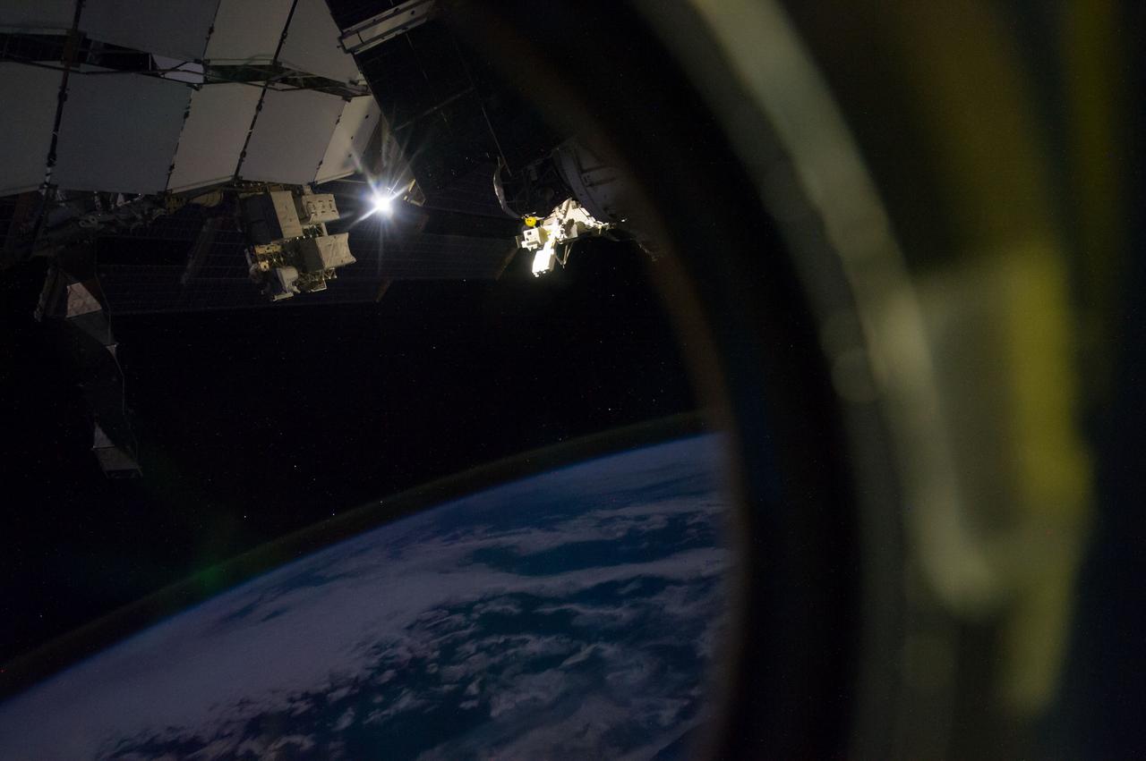 ISS040-E-129695 (6 Sept. 2014) --- A close look at this image, photographed by one of the Expedition 40 crew members onboard the International Space Station at 228 nautical miles above Earth, reveals a minor appearance of the Aurora Australis at lower left frame. The image was taken as the orbital outpost was flying over the Indian Ocean, several hundred miles southeast of the African continent. The camera's exposure time created an "exploded flare" effect from what appears to be the moon at upper left. The NanoRacks Cubesat deployer, attached to the Japan Aerospace Exploration Agency’s Kibo robotic arm, can be seen in upper center.