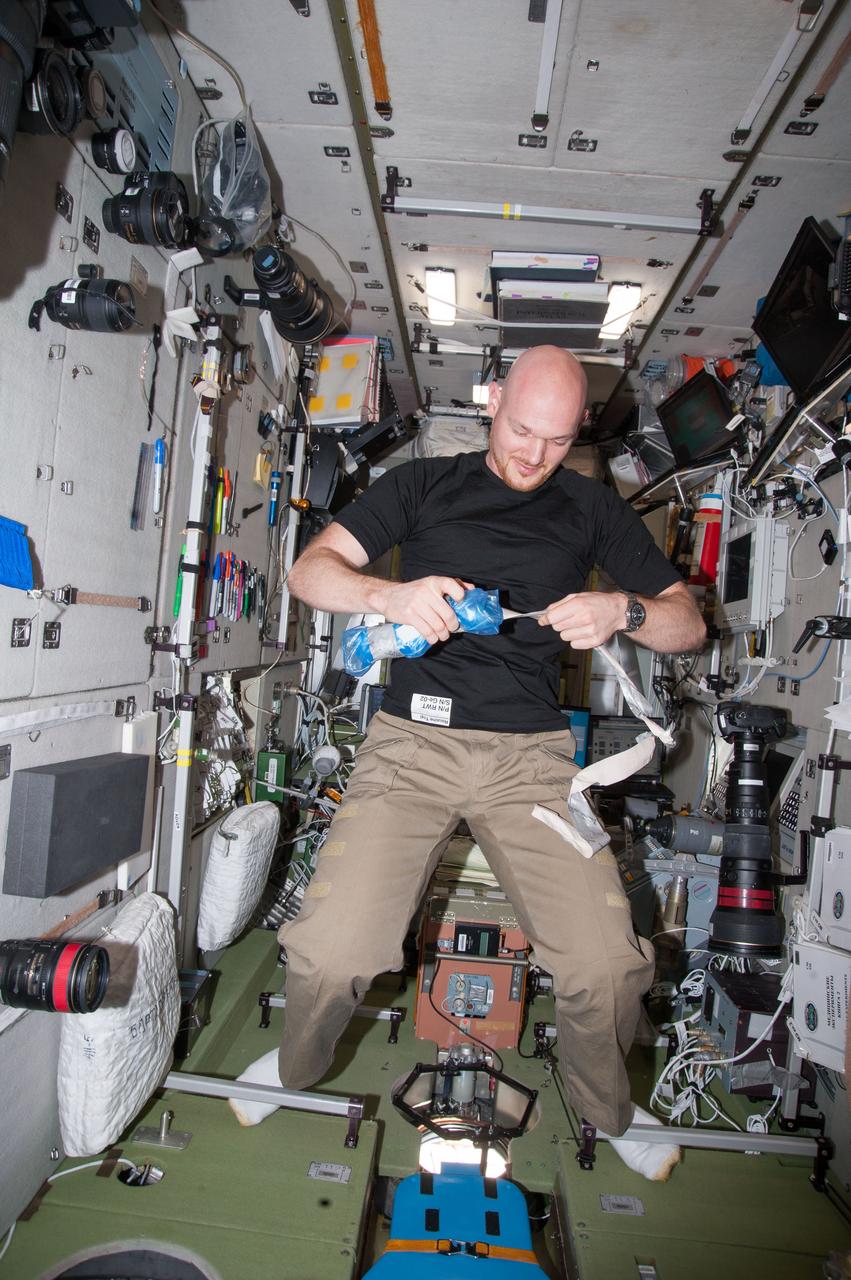 ISS040-E-130020 (9 Sept. 2014) --- European Space Agency astronaut Alexander Gerst, Expedition 40 flight engineer, opens a package of dosimeters in the Zvezda Service Module of the International Space Station.