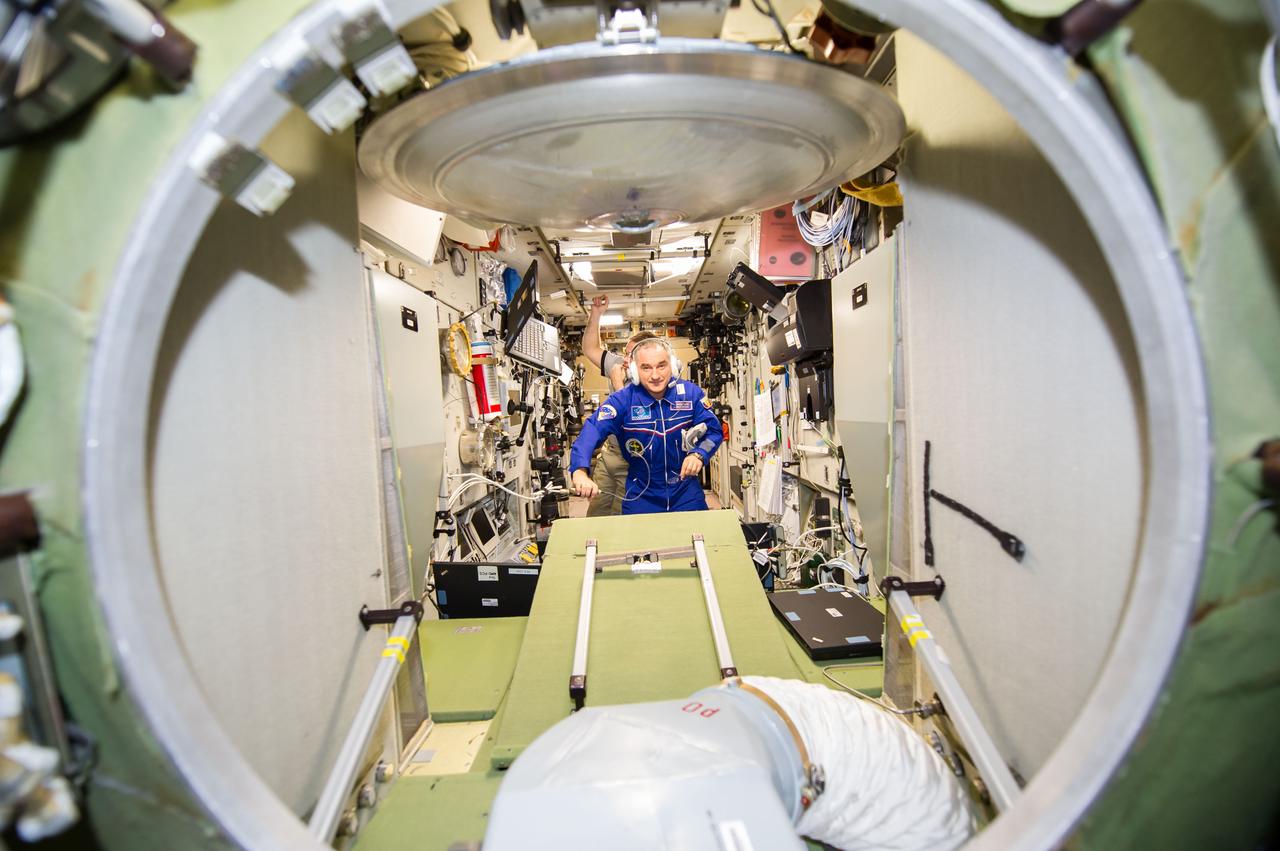 ISS040-E-139786 (10 Sept. 2014) --- Russian cosmonauts Alexander Skvortsov, Expedition 40 flight engineer; and cosmonaut Maxim Suraev, Expedition 41 commander, work in the Zvezda Service Module of the International Space Station.