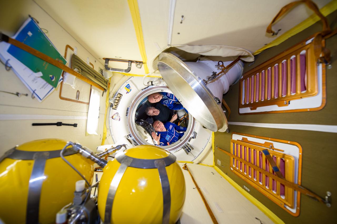 ISS040-E-139841 (10 Sept. 2014) --- NASA astronaut Steve Swanson (center), Expedition 40 commander; along with Russian cosmonauts Alexander Skvortsov (bottom) and Oleg Artemyev, both flight engineers, are pictured in the Soyuz TMA-12M capsule which will return them back to Earth after serving more than five months onboard the orbital outpost. Undocking from the International Space Station’s Poisk Mini-Research Module 2 (MRM2) occurred at 7:01 p.m. (EDT) on Sept. 10, 2014.