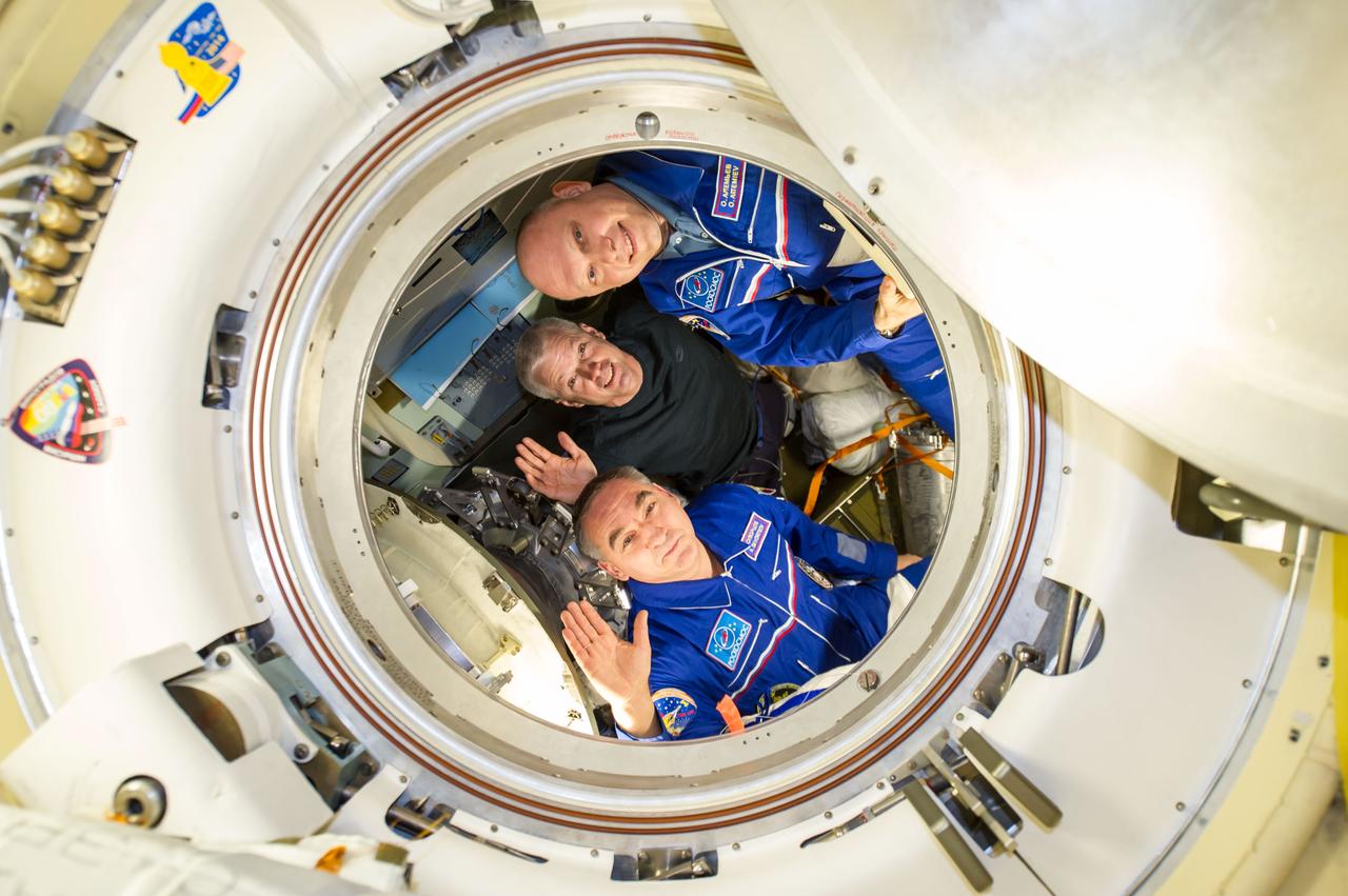 ISS040-E-139842 (10 Sept. 2014) --- NASA astronaut Steve Swanson (center), Expedition 40 commander; along with Russian cosmonauts Alexander Skvortsov (bottom) and Oleg Artemyev, both flight engineers, are pictured in the Soyuz TMA-12M capsule which will return them back to Earth after serving more than five months onboard the orbital outpost. Undocking from the International Space Station’s Poisk Mini-Research Module 2 (MRM2) occurred at 7:01 p.m. (EDT) on Sept. 10, 2014.