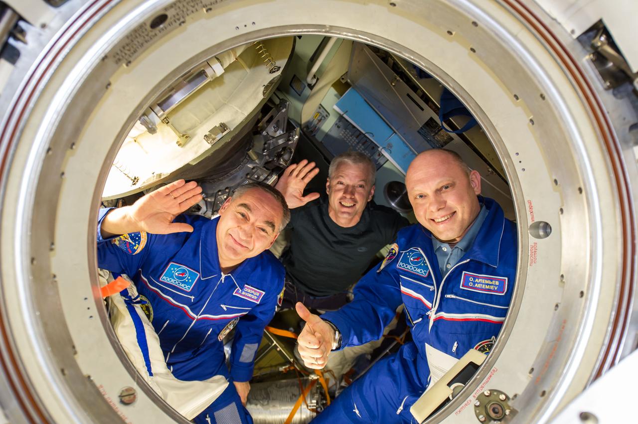 ISS040-E-139846 (10 Sept. 2014) --- NASA astronaut Steve Swanson (center), Expedition 40 commander; along with Russian cosmonauts Alexander Skvortsov (left) and Oleg Artemyev, both flight engineers, are pictured in the Soyuz TMA-12M capsule which will return them back to Earth after serving more than five months onboard the orbital outpost. Undocking from the International Space Station’s Poisk Mini-Research Module 2 (MRM2) occurred at 7:01 p.m. (EDT) on Sept. 10, 2014.