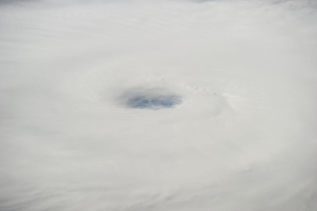ISS041-E-011536 (16 Sept. 2014) --- This is the eye of Hurricane Edouard in the Atlantic Ocean, as photographed by one of the Expedition 41 crew members who utilized a 200mm focal length from a position onboard the International Space Station. The crew members photographed and distributed a series of images of the storm via station-to-ground downlinks and via social media. Though having been upgraded from a tropical storm to a Category 2 hurricane, the Atlantic-borne Edouard thus far has avoided land interests as it reached maximum sustained winds of 105 miles per hour, churning in ocean waters several hundred miles southeast of Bermuda.  This photo was taken at 13:52:40 GMT on Sept. 16, 2014.