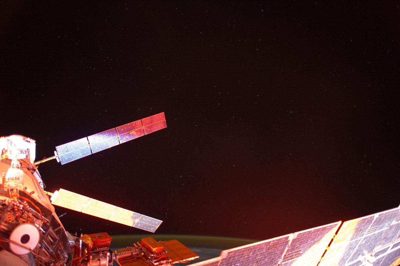 ISS041-E-013687 (13 Sept. 2014) ---   Photographed with a mounted automated camera, this is one of a number of images featuring the European Space Agency?s Automated Transfer Vehicle (ATV-5 or Georges Lemaitre) docked with the International Space Station.  Except for color changes, the images are almost identical.  The variation in color from frame to frame is due to the camera?s response to the motion of the orbital outpost, relative to the illumination from the sun.